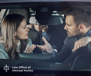 Two parents having a discussion inside a car