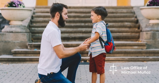 A man and his son holding hands