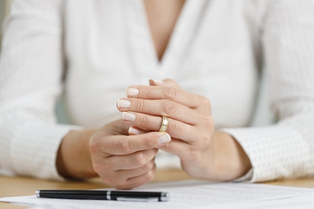 woman taking off wedding ring