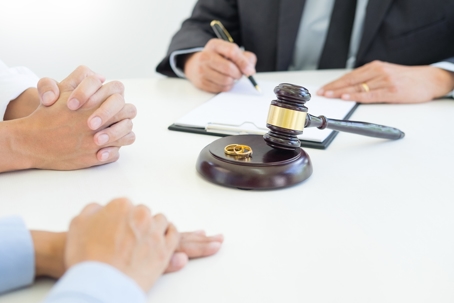 divorcing couple going through document with a lawyer