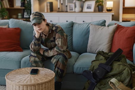 sad service member sitting on the couch